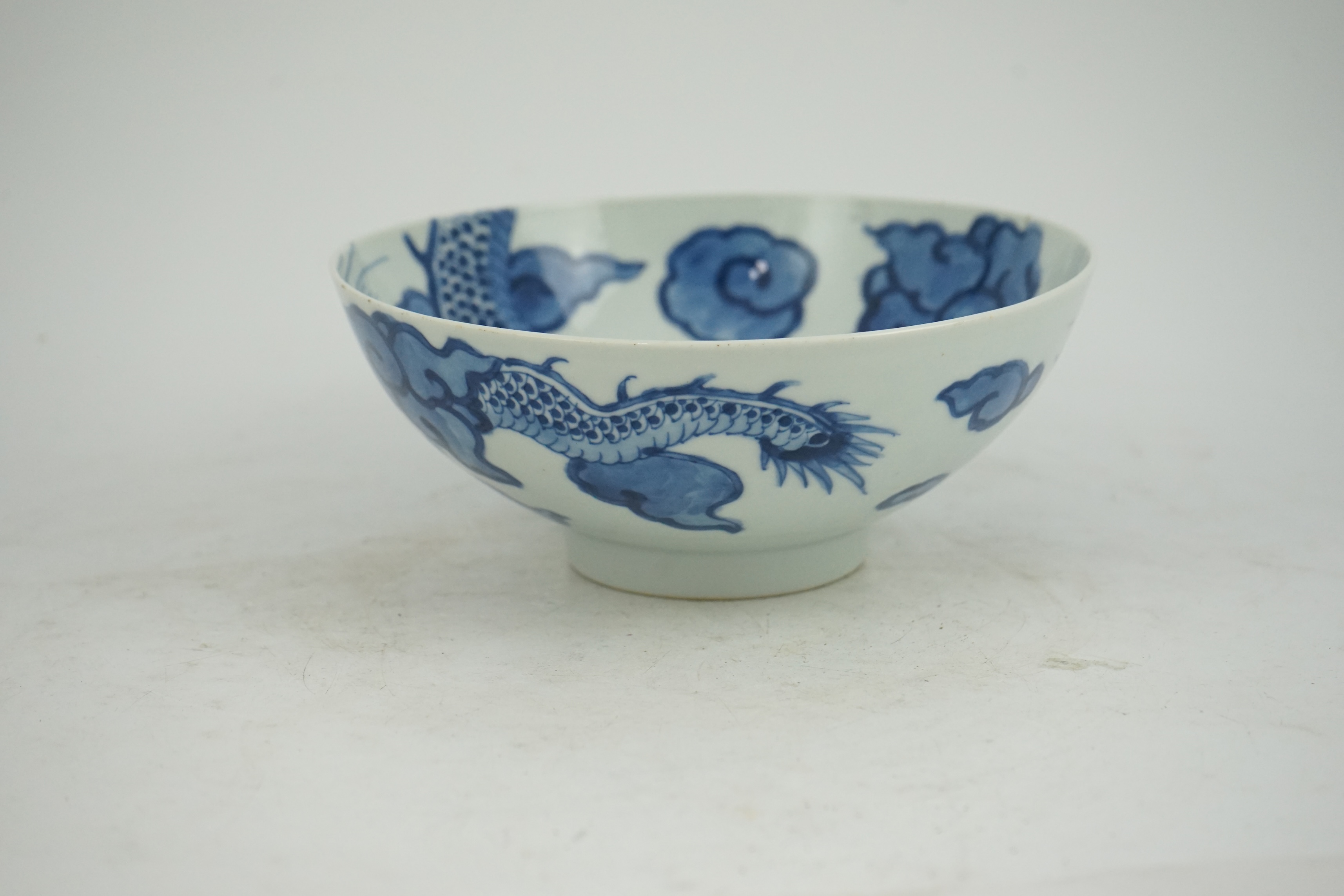 A Chinese blue and white ‘cloud and dragon’ bowl, Yongzheng mark and period (1723-35)